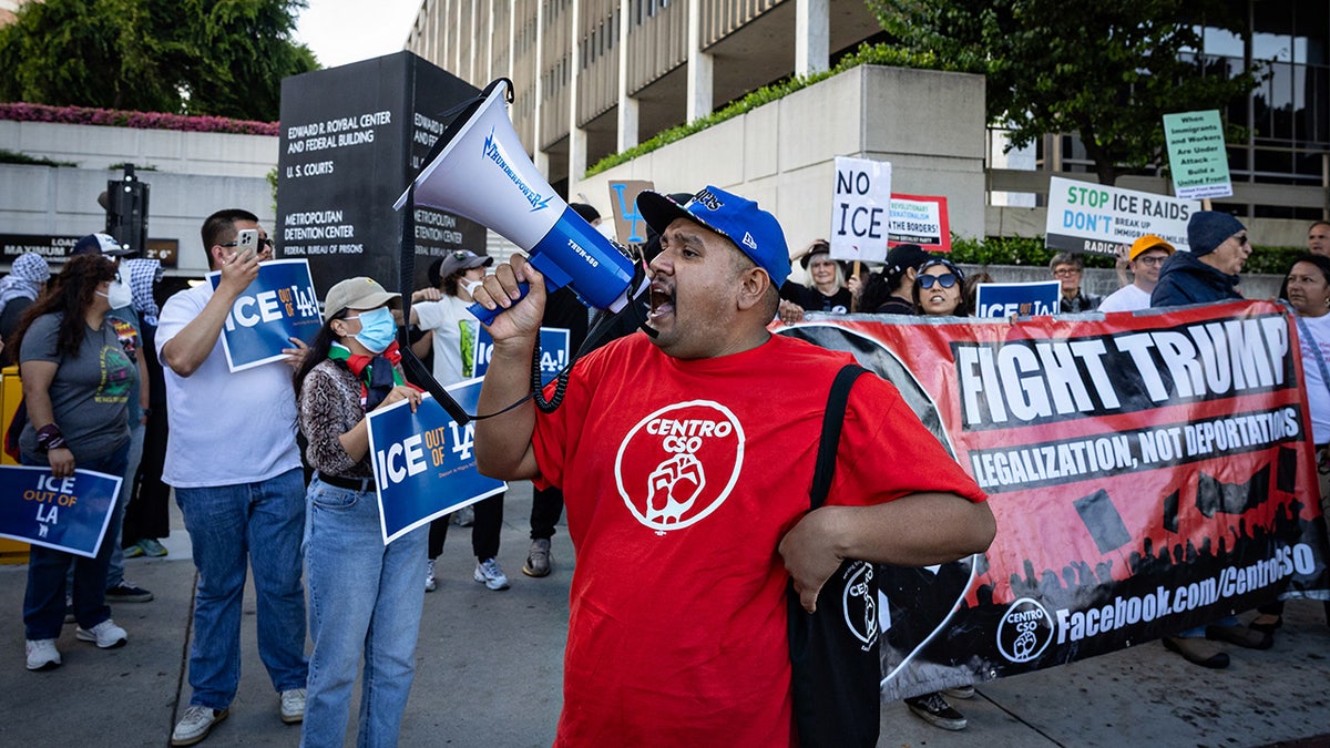 Demonstrators protest outside the Edward R. Roybal Federal Building and the Metropolitan Detention Center in response to ICE raids in Los Angeles on Friday, June 6, 2025, in Los Angeles.