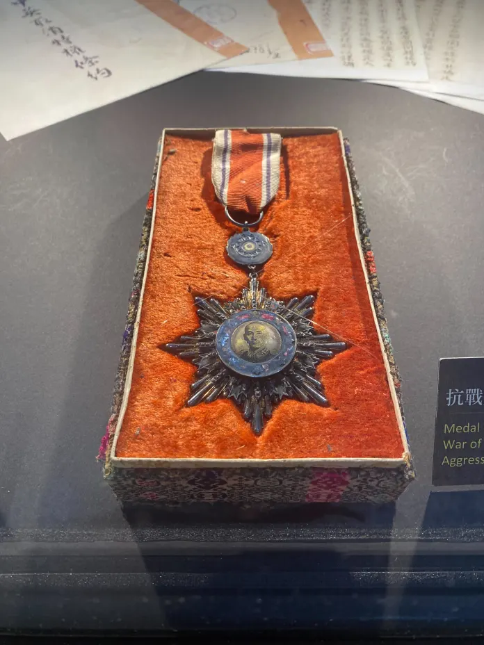 A medal bearing the image of Chiang Kai-Shek celebrating Chinese victory in the Second Sino-Japanese War, known in Taiwan as the War of Resistance against Japanese Aggression, housed in a display case at Kuomintang headquarters. (Photo: Timothy Nerozzi)