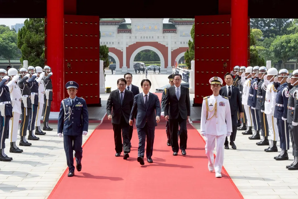 In this photo released by the Taiwan Presidential Office, Taiwan's President Lai Ching-te, center, arrives for a ceremony honoring soldiers and officials during Taiwan's Armed Forces Day on Wednesday, Sept. 3, 2025, in Taipei, Taiwan. (Taiwan Presidential Office via AP)