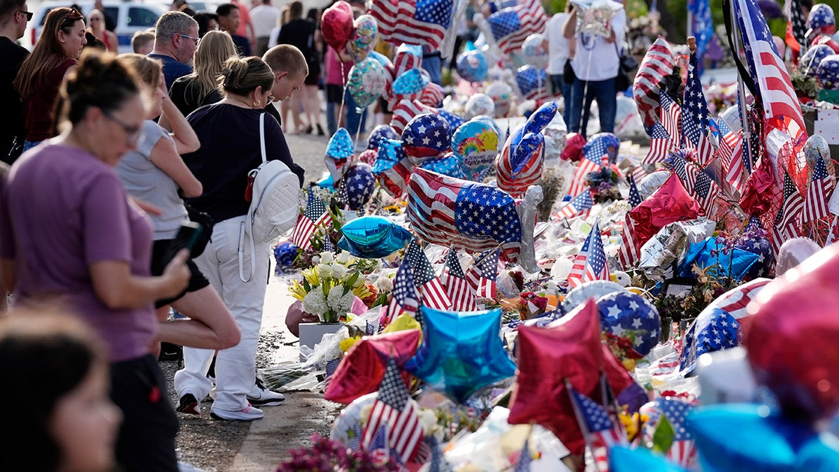 Well-wishers add to a makeshift memorial set up at Turning Point USA headquarters in honor of Charlie Kirk, the later 31-year-old founder and CEO of the organization, on Wednesday, Sept. 17, 2025, in Phoenix, Ariz.