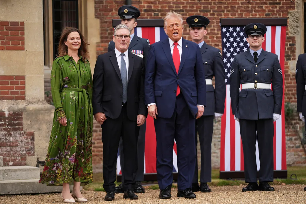 President Donald Trump reacts next to Britain's Prime Minister Keir Starmer and his wife Victoria Starmer upon arriving at Chequers near Aylesbury, England, Thursday, Sept. 18, 2025. 