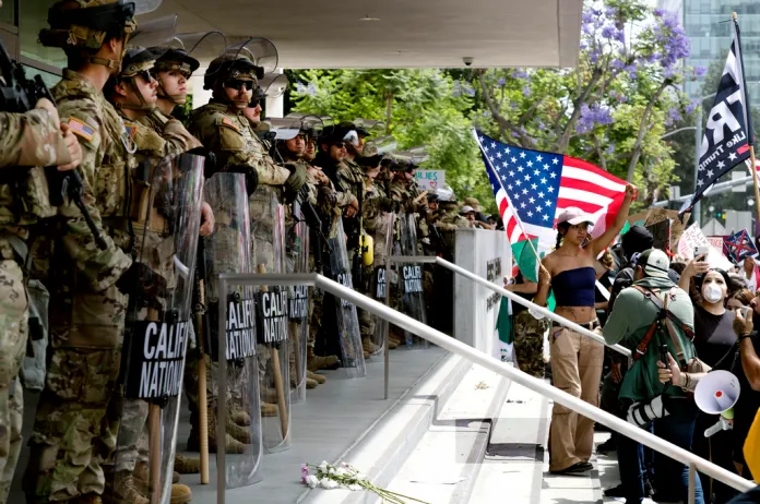 Protesters stand off against California National Guard soldiers at the Federal Building in downtown Los Angeles during a "No Kings" protest, June 14, 2025.