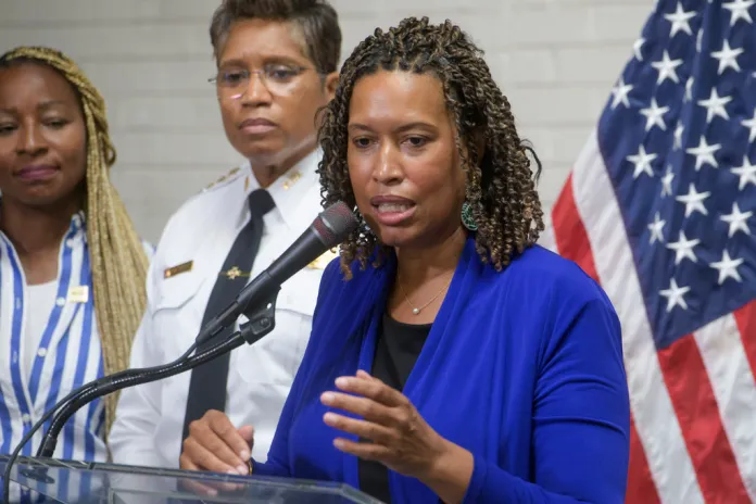 Pamela Smith, Chief of Police, Metropolitan Police Department, center, listens as District of Columbia Mayor Muriel Bowser, right, fields questions from reporters during a news conference at Phelps Architecture Construction and Engineering High School in Washington, Wednesday, Aug. 20, 2025.