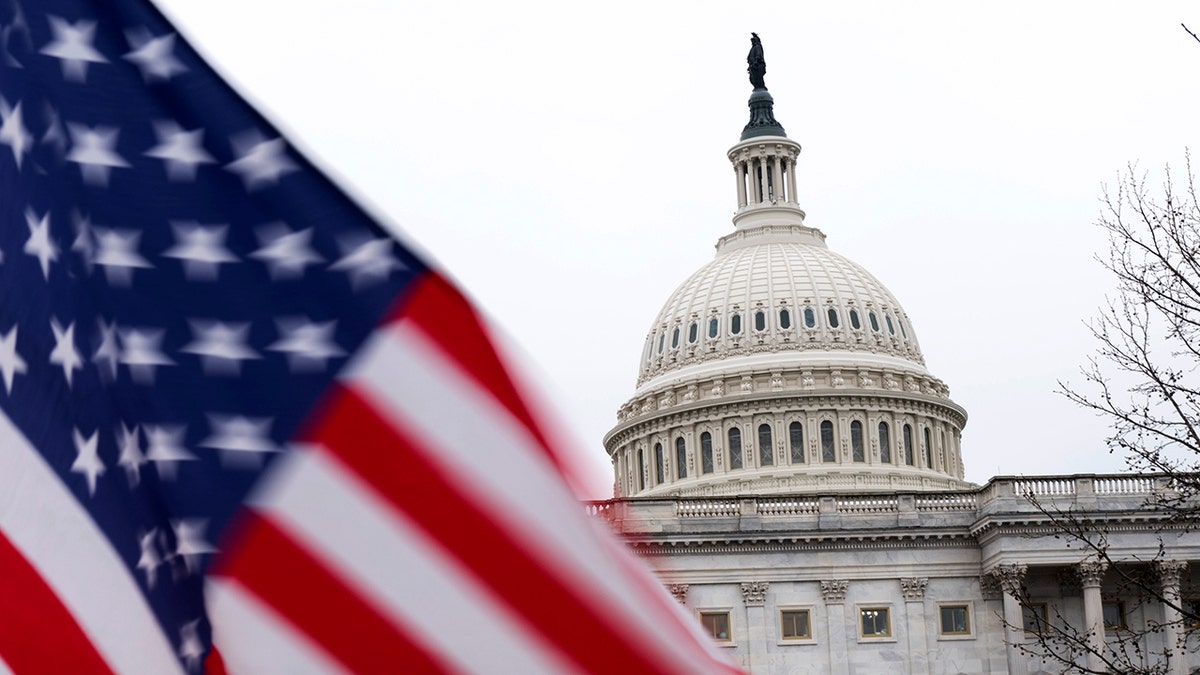A US flag flies near the Capitol