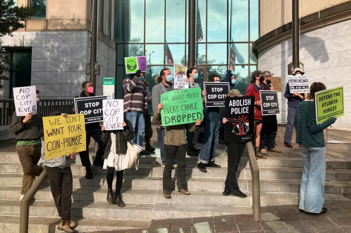 Demonstrators gather outside of Atlanta's City Hall on Tuesday, Jan. 31, 2023, as local officials announce they are moving forward with plans to build the Atlanta Public Safety Training Center. The protesters have called for officials to abandon plans for the project, which they call Cop City.
