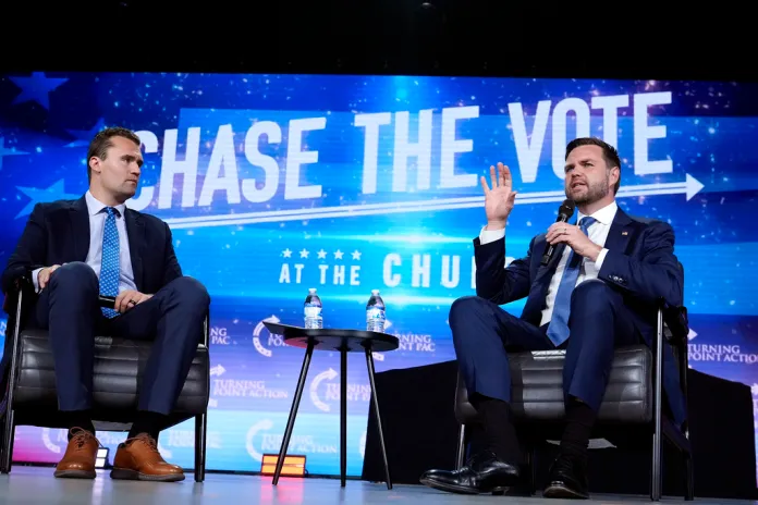 Republican vice presidential nominee Sen. JD Vance, R-Ohio, right, speaks at a campaign event as Turning Point USA Founder Charlie Kirk, left, listens Wednesday, Sept. 4, 2024, in Mesa, Ariz.