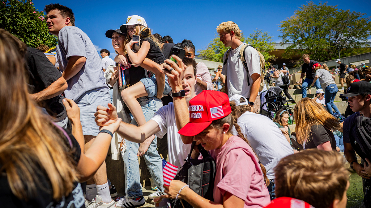 The crowd reacts after Charlie Kirk is shot