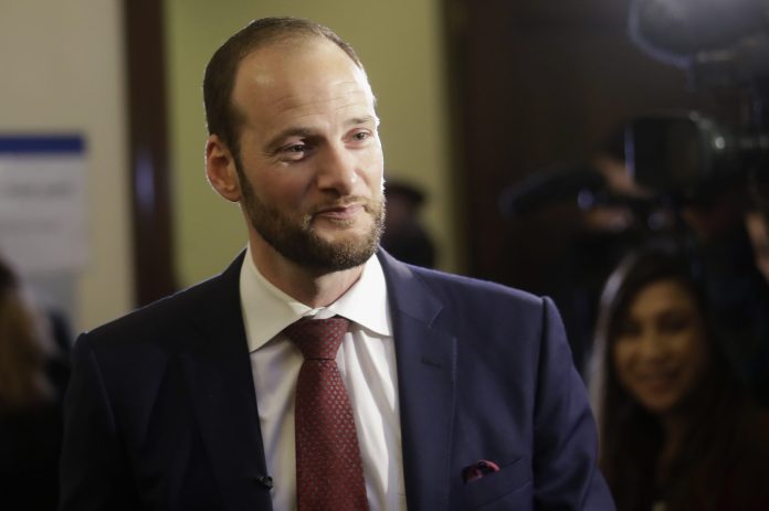 San Francisco District Attorney Chesa Boudin speaks to reporters before his swearing-in ceremony.