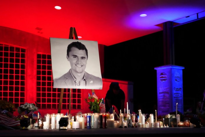 A photo of Charlie Kirk, the CEO and co-founder of Turning Point USA who was shot and killed, stands at his vigil, Thursday, Sept. 11, 2025, in Orem, Utah. (AP Photo/Lindsey Wasson)
