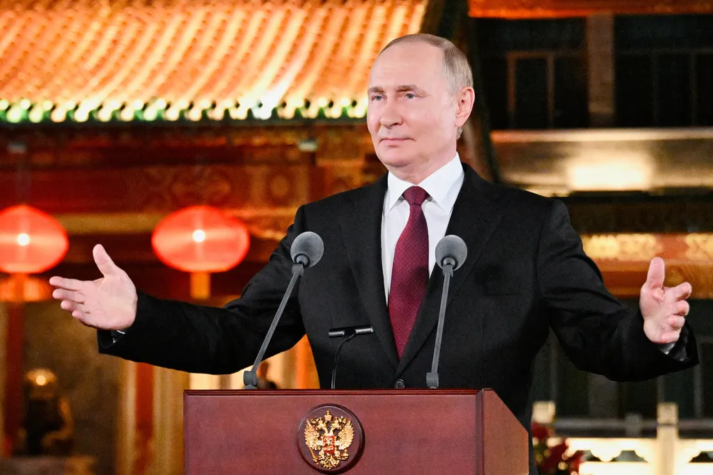 Russian President Vladimir Putin gestures during a press conference.