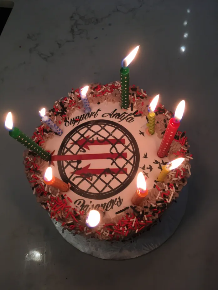 To celebrate its defense fund's 10th year in operation, Antifa International posted a picture of a cake with icing saying "Support Antifa Prisoners"