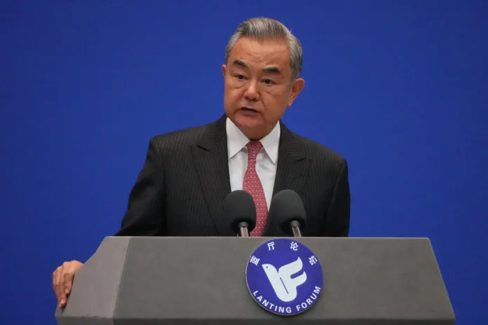 Chinese Foreign Minister Wang Yi speaks at a podium.