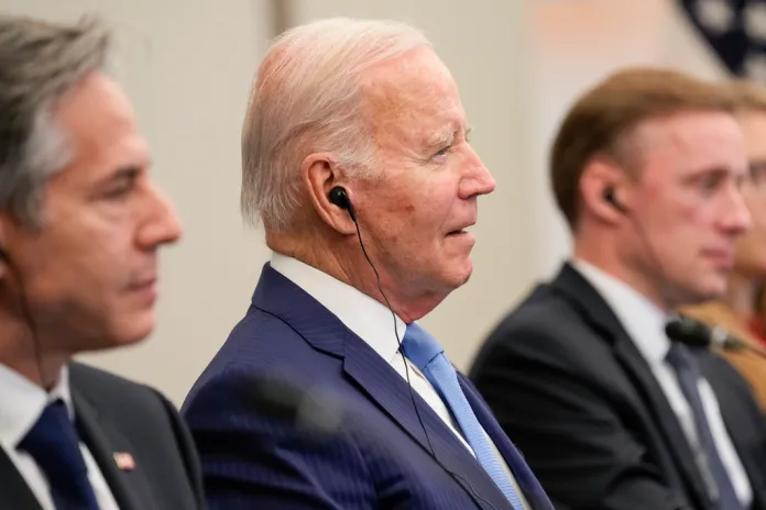President Joe Biden, center, sits with Secretary of State Antony Blinken, left, and National Security Advisor Jake Sullivan.