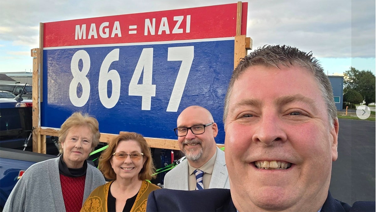 Michigan Democrats pose in front of anti-Trump sign with controversial language