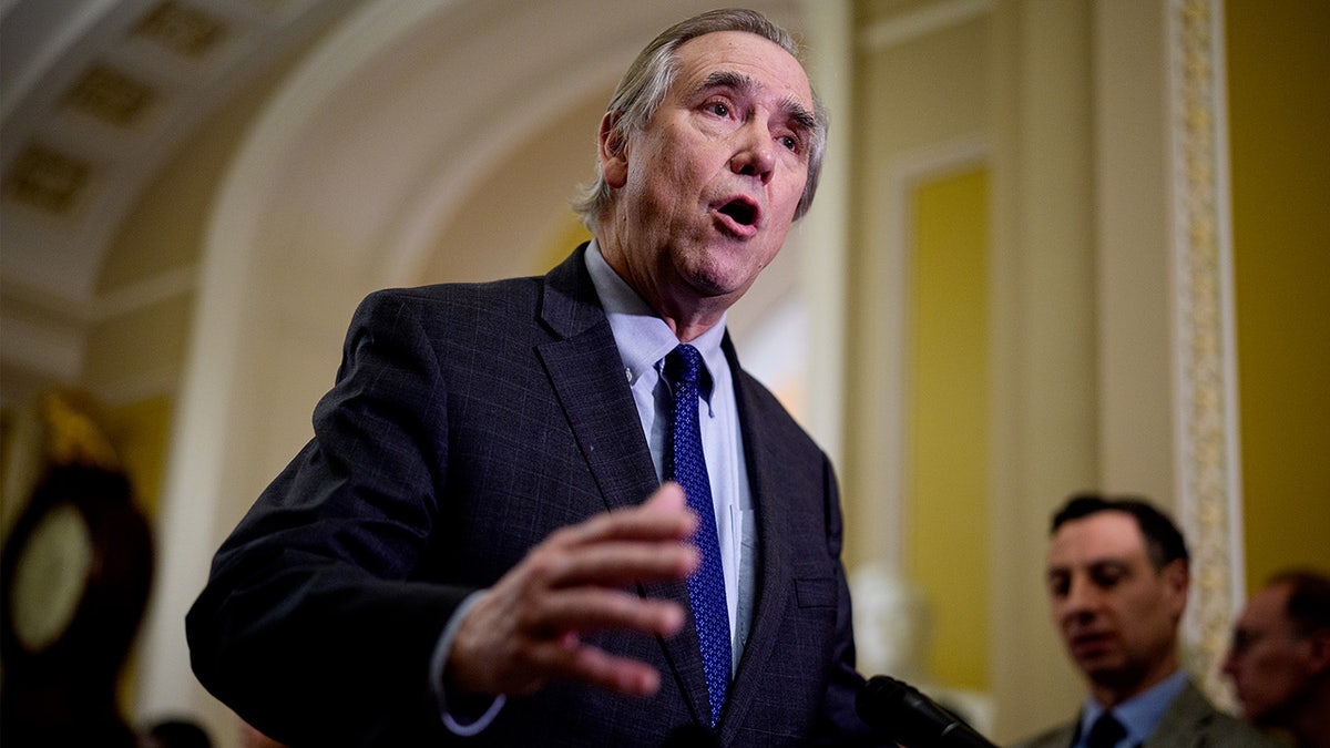 Sen. Jeff Merkley speakers to reporters in the Capitol building