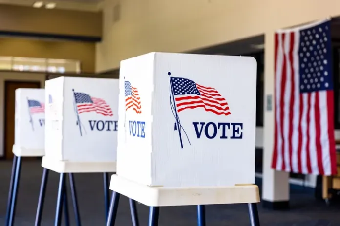 Voting booths set up in rows on Election Day. (Photo credit: iStock)