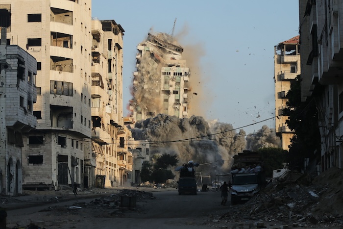 Smoke rises from an Israeli airstrike on the Macca Tower, a high-rise building in Gaza City,.