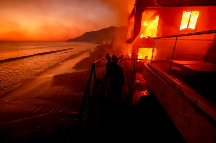 Firefighters work from a deck.