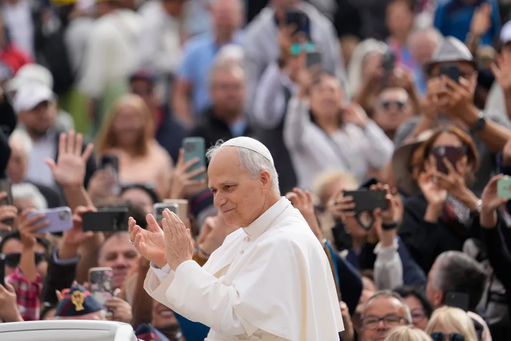Pope Leo XIV applauds as he arrives for his weekly general audience in St. Peter's Square.