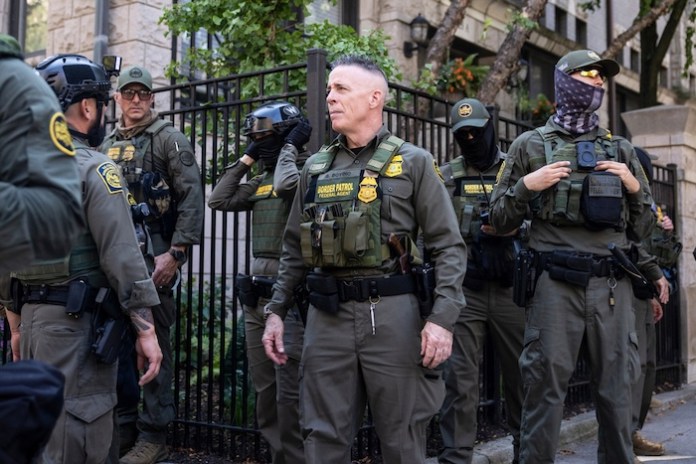 Greg Bovino, the chief patrol agent for the U.S. Border Patrol El Centro sector, stands with federal immigration agents on North Clark Street near West Oak Street in River North, Sunday, Sept. 28, 2025, in Chicago (Ashlee Rezin/Chicago Sun-Times via AP)