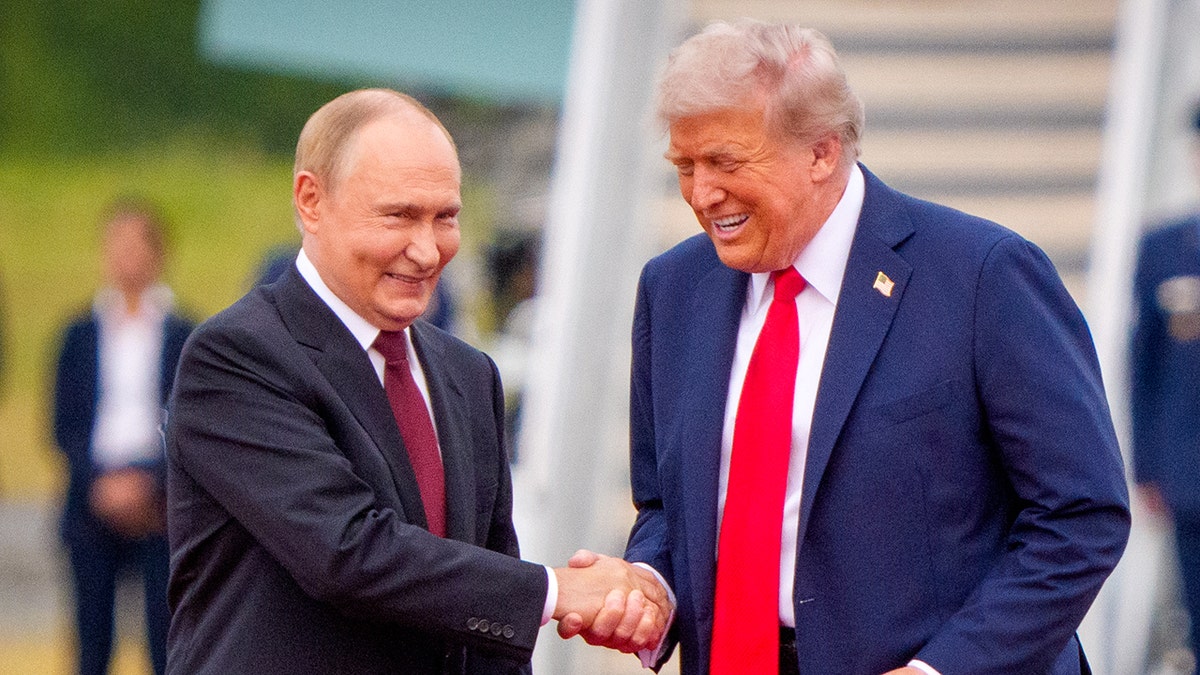 U.S. President Donald Trump shakes hands with Russian President Vladimir Putin