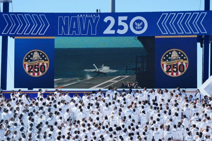 Sailors watch a show of force exercise.