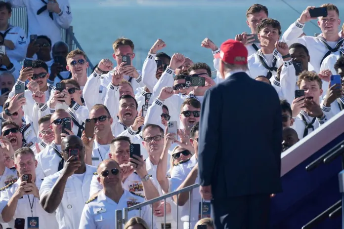 Trump greets the sailors in the crowd.