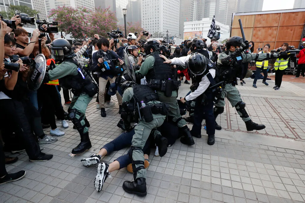 Chinese police detain protesters during a rally.