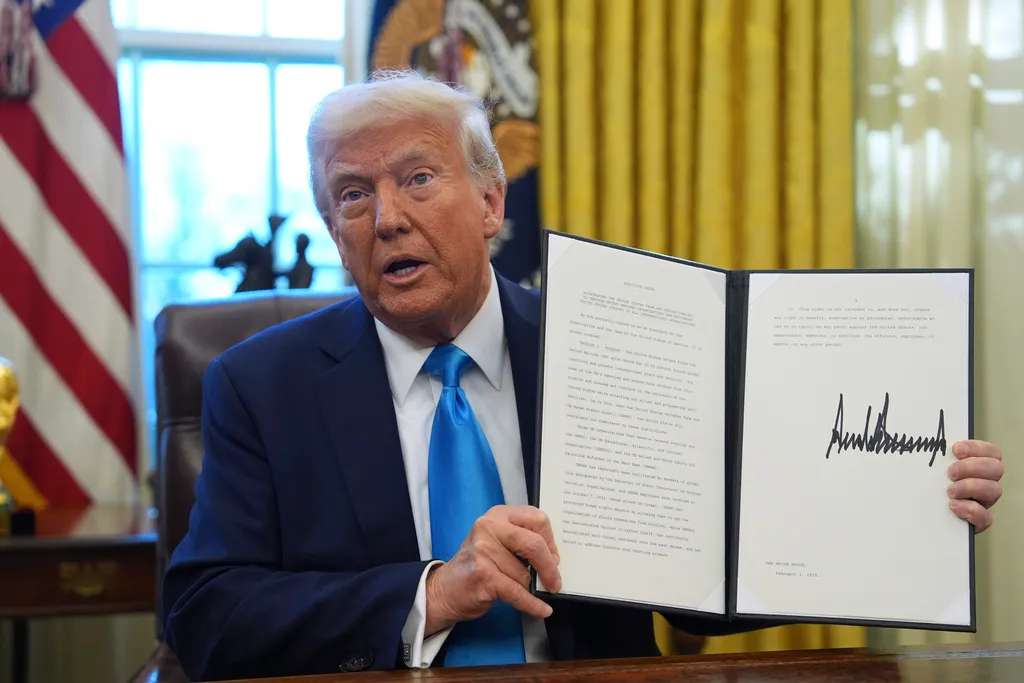 President Donald Trump holds an executive order.
