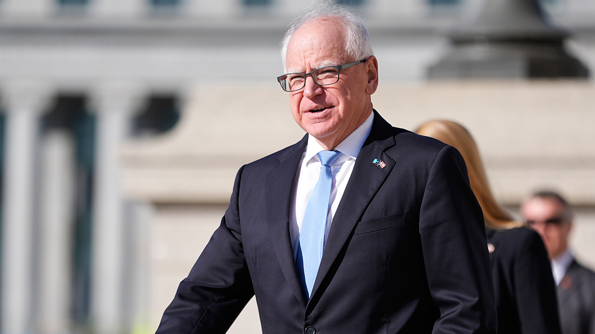 Gov. Tim Walz walks near the Minnesota state capitol building