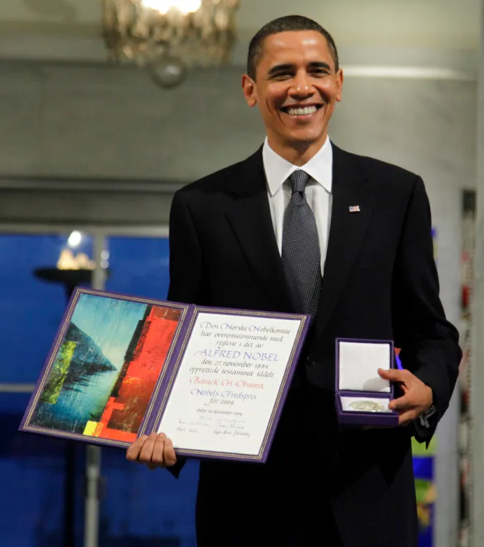 President Barack Obama holds his Nobel Peace Prize in 2009.