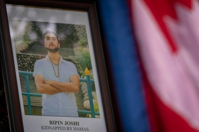 A portrait of Bipin Joshi is displayed at an event held at the Israeli Ambassador's residence in Kathmandu during which Joshi's family members appealed for his prompt release and that of all other hostages currently being held captive by Hamas, in Kathmandu, Nepal, Thursday, April 18, 2024. (AP Photo/Niranjan Shrestha)
