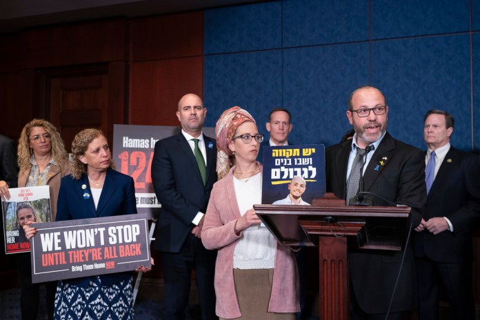 Rep. Debbie Wasserman Schultz, D-Fla., left, stands with Israeli Knesset Speaker Amir Ohana, as they listen to Ditza Mor, and Tzvika Mor, parents of Eitan Mor, a security guard kidnapped on October 7, during an event with families of hostages taken during the Hamas attacks, at the Capitol in Washington, Wednesday, Feb. 7, 2024. (AP Photo/J. Scott Applewhite)