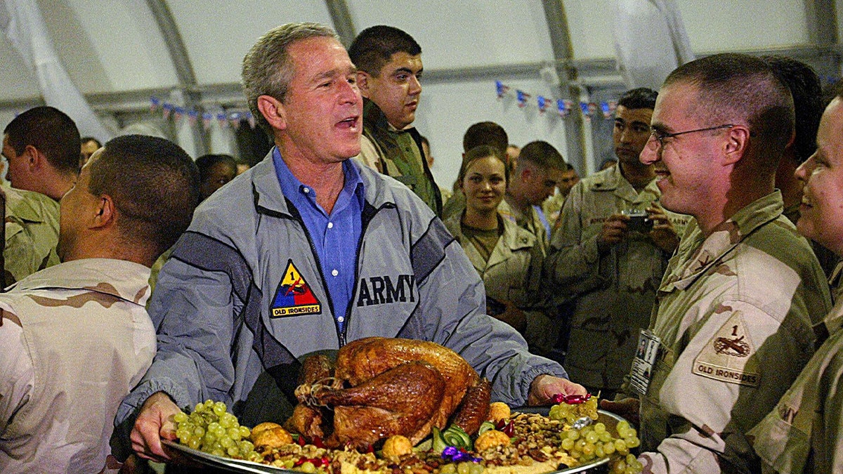President Bush holding a turkey in Iraq