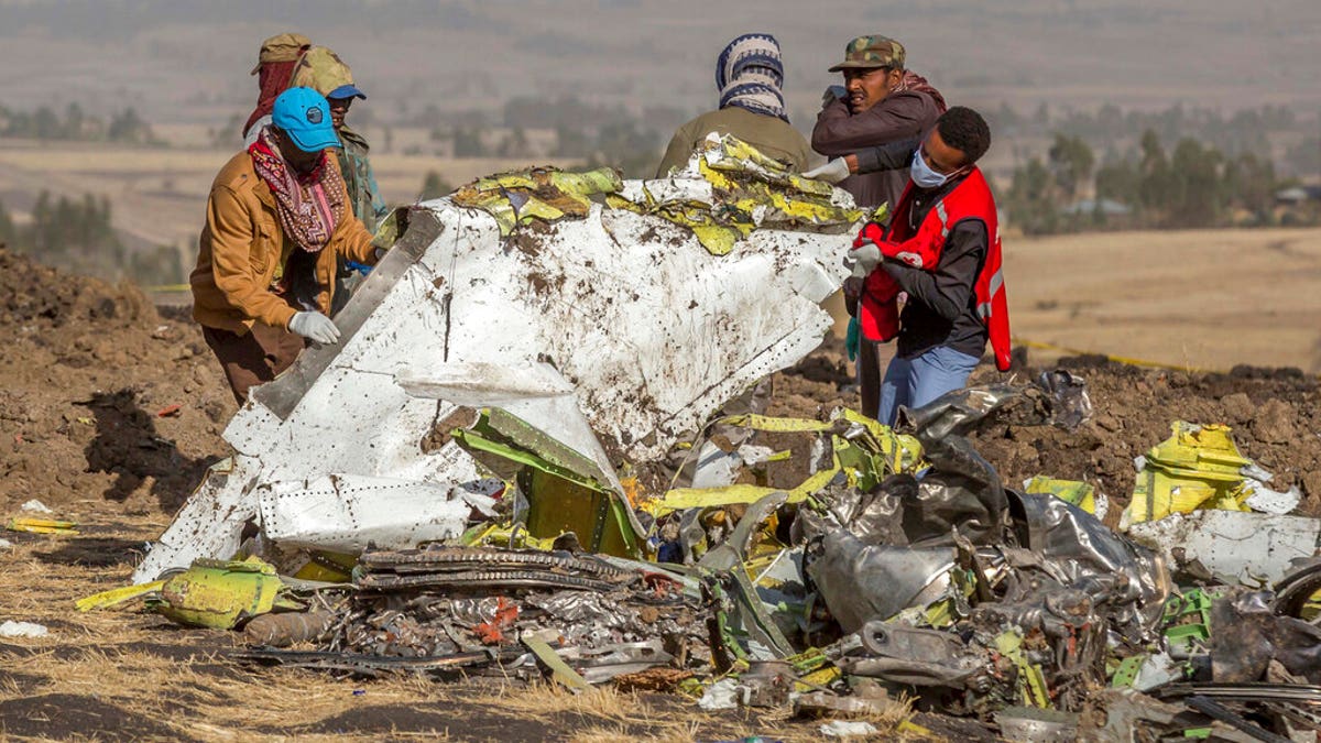 People work at the scene of an Ethiopian Airlines flight crash near Bishoftu, or Debre Zeit, south of Addis Ababa, Ethiopia, March 11, 2019.