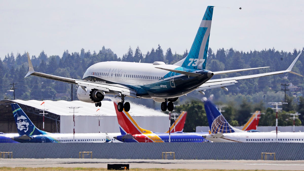 A Boeing 737 MAX jet lands in Seattle after a test flight to evaluate Boeing's proposed changes to the automated flight control system on the MAX, a system that activated erroneously on two flights that crashed, killing 346 people.