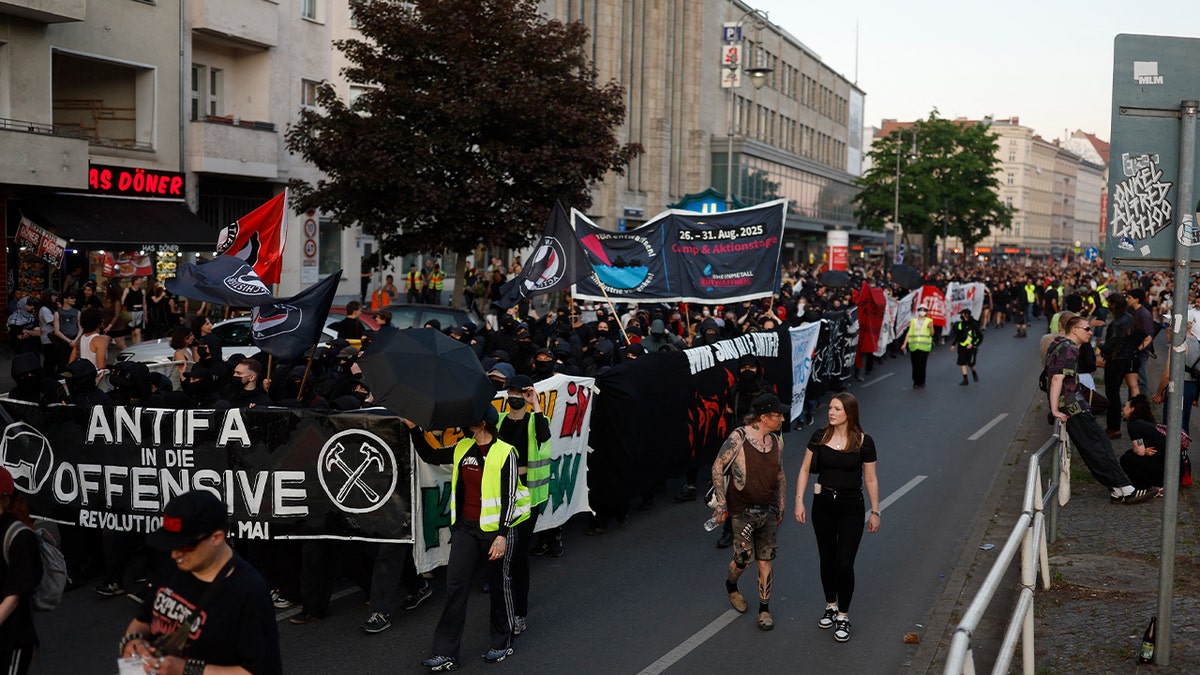 Demonstrators hold up antifa flags and banners during the Revolutionary 1st of May demonstration in Berlin's Neukoelln district on Labour Day, May 1, 2025, in Berlin, Germany.
