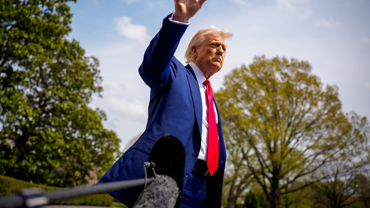 President Donald Trump gestures to reporters before boarding Marine One on the South Lawn of the White House. The appearance came a day after he announced sweeping new tariffs on imports from China, Japan, and India.