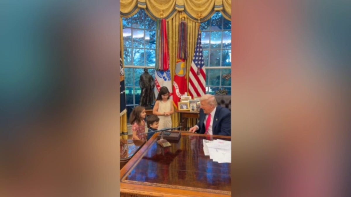 President Trump greets visiting children in Oval Office.