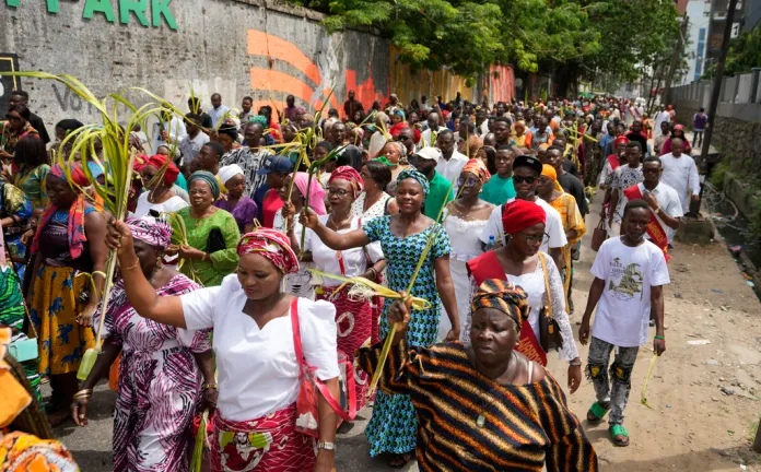 Catholic faithfuls march carrying Palm fronds to commemorate Palm Sunday.