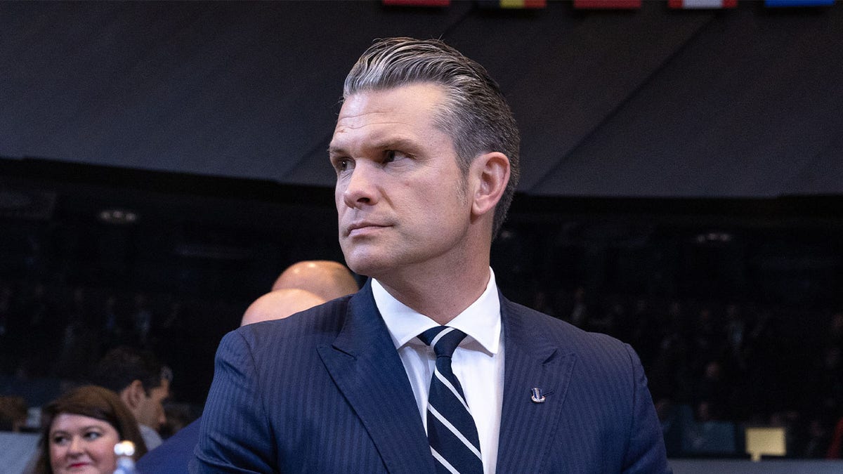 Secretary Pete Hegseth wearing a suit and tie.