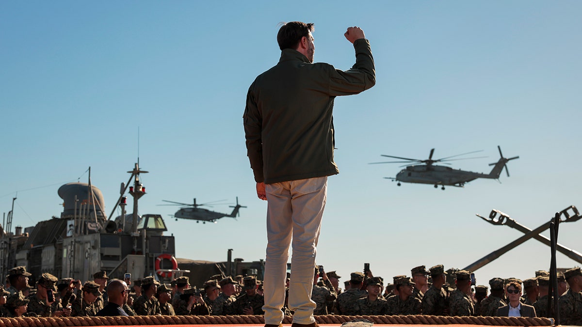 JD Vance raises fist at Marine Corps anniversary event.