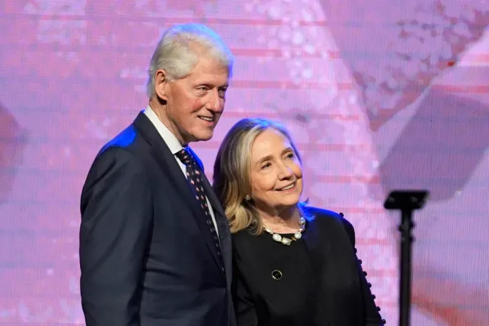 Former President Bill Clinton, left, and former Secretary of State Hillary Clinton listen as Vice President Kamala Harris delivers a eulogy for U.S. Rep. Sheila Jackson Lee, Thursday, Aug. 1, 2024, in Houston. (AP Photo/LM Otero)