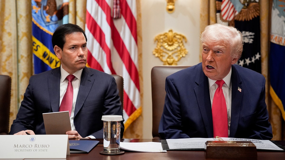 Marco Rubio listens to Donald Trump during a Cabinet meeting