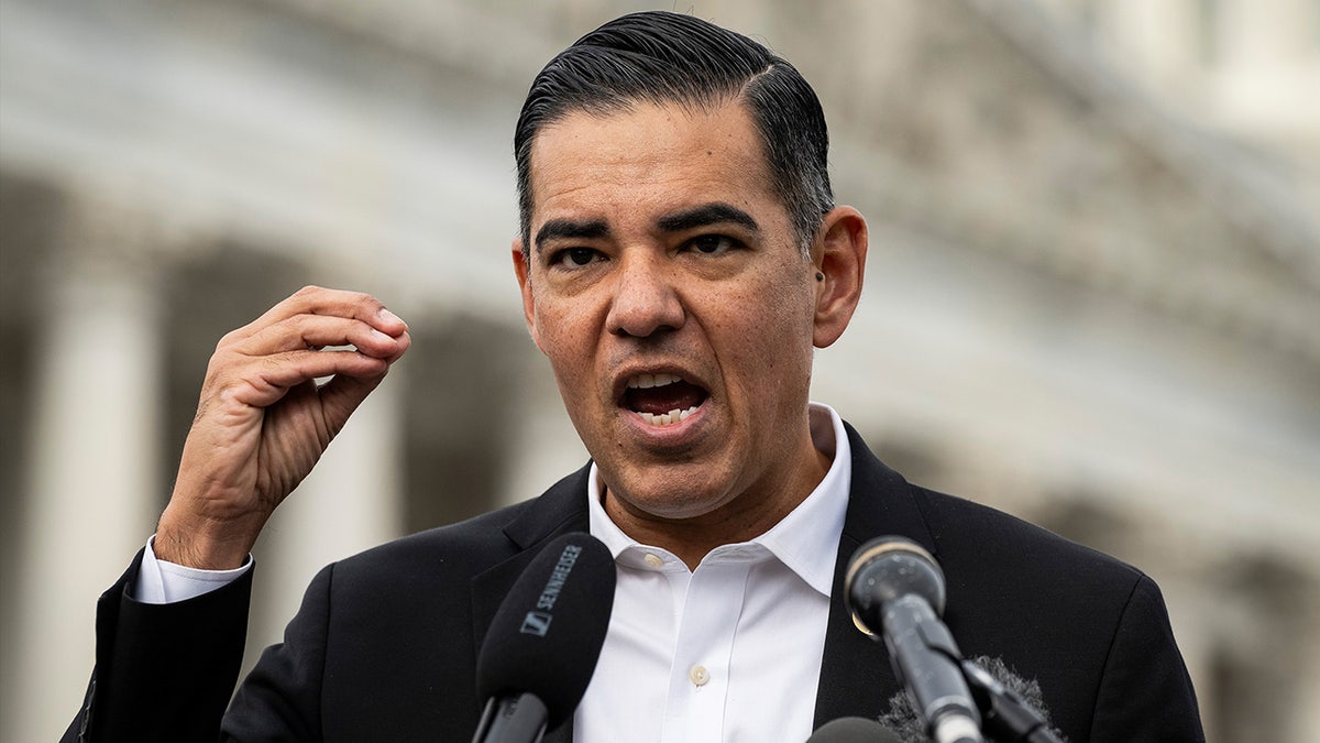 Robert Garcia stands at podium