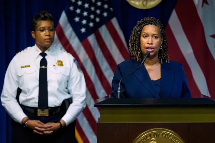 D.C. Mayor Muriel Bowser speaks as Metropolitan Police Department Chief Pamela Smith listens during a news conference on President Donald Trump's plan to place Washington police under federal control and deploy National guard troops to Washington, Monday, Aug. 11, 2025, in Washington.