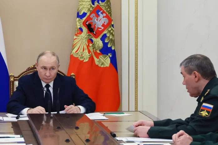 Russian President Vladimir Putin listens to Russian Gen. Valery Gerasimov, chief of general staff, during a meeting with senior military officers at the Kremlin in Moscow.
