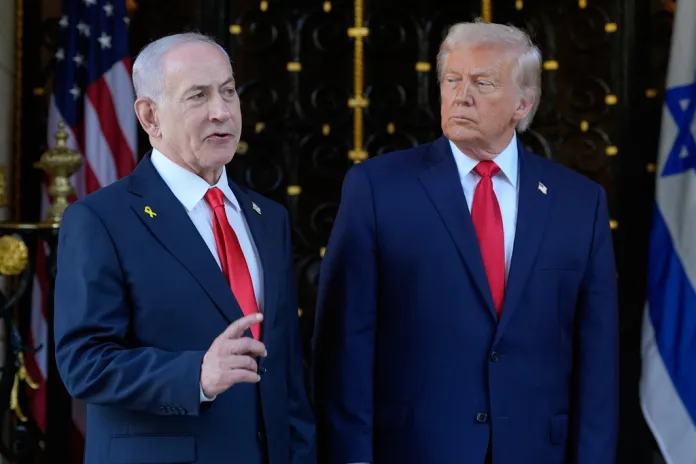President Donald Trump listens as Israel's Prime Minister Benjamin Netanyahu speaks at Trump's Mar-a-Lago club.