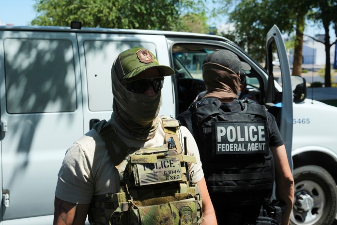 ICE and HSI police protect a van.