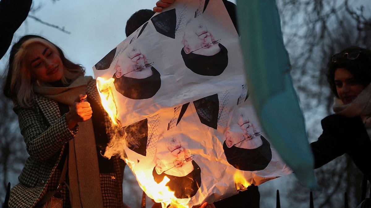 Demonstrators burn pictures of Iran's Supreme Leader Ayatollah Ali Khamenei outside the Iranian embassy during a rally in support of nationwide protests in Iran, in London, Jan. 12, 2026.&nbsp;